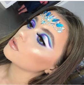 Close-up of geometric acrylic forehead rhinestone stickers on a professional model