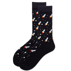 Detail of black crew sock with knitted cartoon rocket and star patterns in space theme