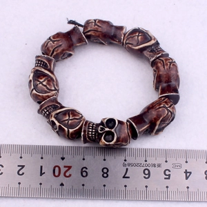 Detail view of punk skull bracelet with vintage bone texture and elastic beads