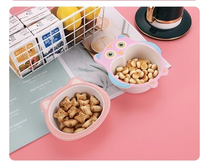 Close-up of pink animal-shaped bamboo fiber bowls for kids featuring a cat and owl design