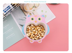 Pink owl bamboo fiber baby bowl filled with small cookies on a soft pink tabletop
