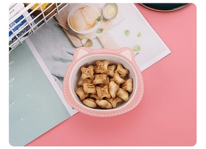 Pink cat-ear bamboo fiber bowl for kids filled with cute bear-patterned biscuits