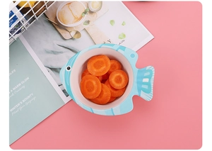 Eco-friendly fish-shaped kids bowl in light blue with fresh carrot slices
