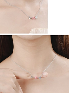 Detailed close-up of Cupid's arrow necklace with pink moonstone and sparkling crystals