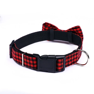 Detail of red and black buffalo plaid pet collar with plastic buckle and metal D-ring