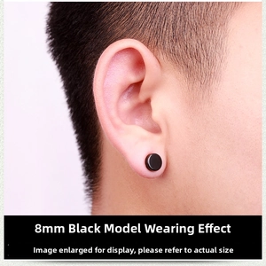 Close-up of 8mm black magnetic stud earring on male ear in punk industrial style