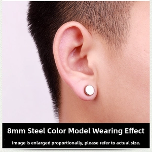 Close-up of 8mm steel silver magnetic earring for men on earlobe without piercing
