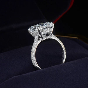 Luxurious radiant cut moissanite ring with pavé band in a velvet jewelry box