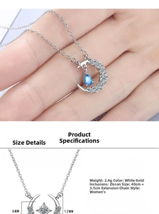 Detail showing moon pendant with blue waterdrop gem and white zircons on silver necklace