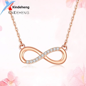 Detailed macro view of an infinity symbol necklace in rose gold with sparkling zircon stones