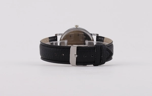 Detail view of the black leather strap and silver buckle with transparent case back