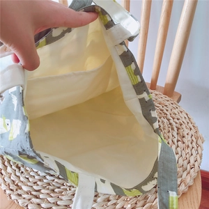 Detail of canvas tote bag interior with small pocket and cute bear pattern