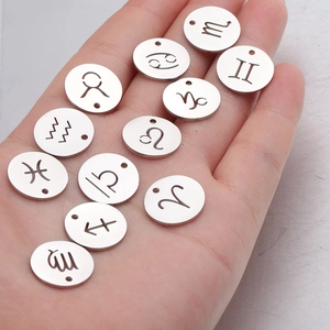 Mirror polished 15mm stainless steel 12 zodiac constellation charms held in palm