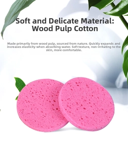 Macro shot of two round pink wood pulp sponges showing soft honeycomb texture and pores
