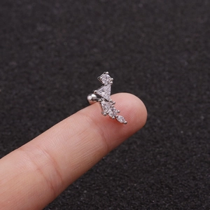 Macro shot of silver surgical steel ear stud with clear cubic zirconia on a finger