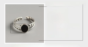 Macro shot of S925 sterling silver ring with black agate inlay and braided texture