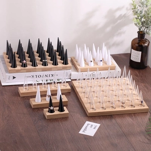 Bamboo ring display stand with conical holders on a wooden table with home decor