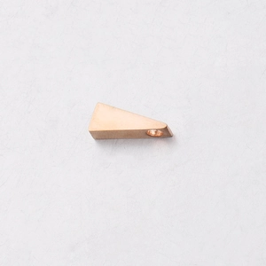 Macro view of a copper-tone triangular stainless steel pendant with a smooth mirror finish