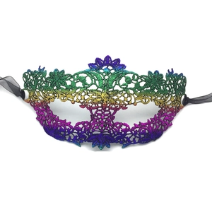 Detailed view of vibrant gradient lace mask with intricate embroidery and black silk ribbons