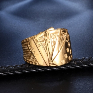 Macro detail of vintage gold poker ring showing Ace King Queen Jack spade engravings