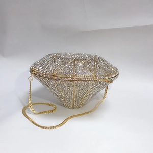 Detail of silver diamond-shaped evening clutch with crystal rhinestones and gold chain