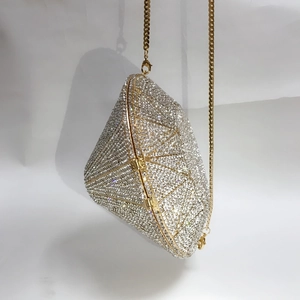 Detail of champagne gold geometric evening clutch with crystal rhinestones and chain strap