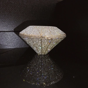 Macro shot of silver crystal rhinestones on geometric diamond evening bag with gold frame