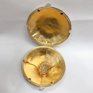 Detail view of the golden interior and crystal embellishments on the spherical clutch