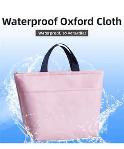 Detail of pink waterproof Oxford cloth lunch bag with navy handles and splash effect
