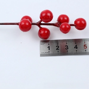 Detail of glossy red artificial berry branches with 10mm fruits for Christmas decor