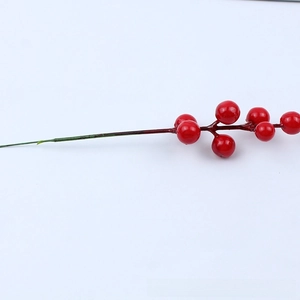 Detailed close-up of realistic artificial red berry branch for Christmas tree decor