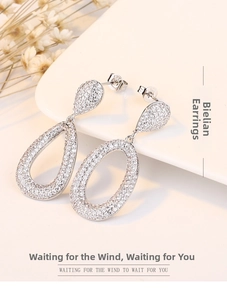 Macro detail of S925 sterling silver water drop earrings with micro-inlaid white zircon