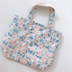 Detailed view of floral canvas tote bag with pink flowers and Animal patterns label