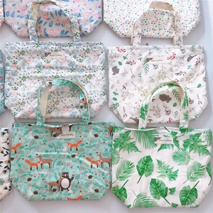 Matrix display of printed cotton canvas tote bags with various floral and animal patterns