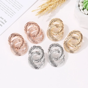 Three pairs of twisted metal stud earrings in gold, silver and rose gold finish