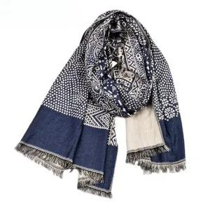 Close-up of navy and cream woven scarf with geometric patterns and fringe detail