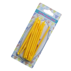 Close-up of manual cake airbrush set with yellow plastic spray pump and vials