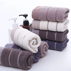 Thick cotton towel set with water-ripple texture in neutral earth tones and soft stack