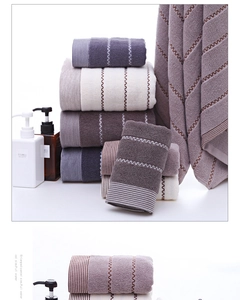 Close-up of thick cotton towels showing vertical stripes and wavy jacquard texture detail