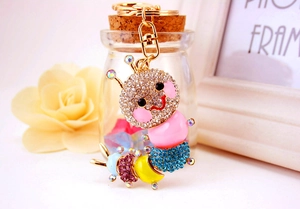 Close-up of a colorful rhinestone caterpillar keychain with gold metal lobster clasp