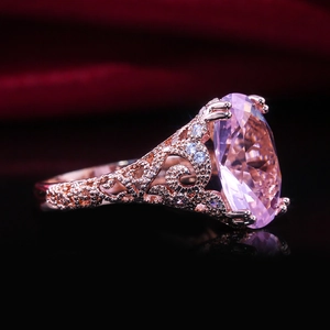 Rose gold engagement ring with oval pink zircon and vintage filigree detailing