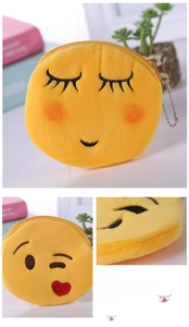Detailed embroidery and metal zipper on a plush yellow emoji smile coin purse with chain