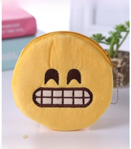 Macro detail of plush yellow emoji coin purse with zipper and metal ball chain