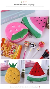 Detail of plush fruit coin purses in strawberry and pineapple shapes with metal zippers