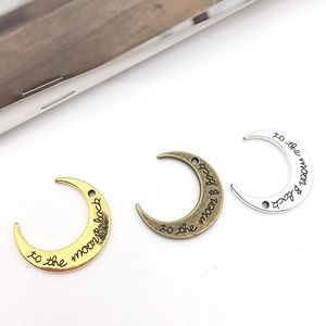 Three moon pendants in gold, bronze, and silver with 'to the moon & back' engraving