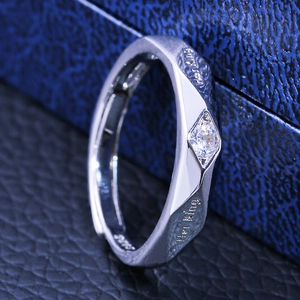 Macro detail of the silver couple ring with Her King engraving and square zircon stone