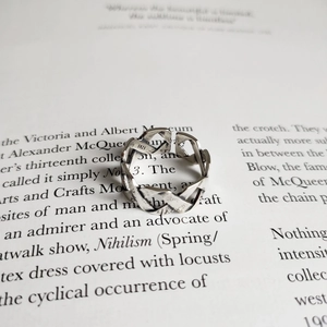 Detail shot of vintage 925 sterling silver woven ring on a stylish magazine background