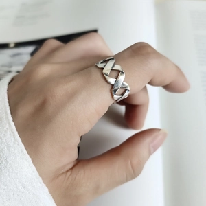 Close-up of vintage 925 silver interlaced ring with oxidized finish on finger