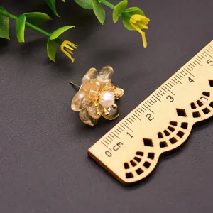 French vintage floral pearl stud earrings in 925 silver shown next to a ruler