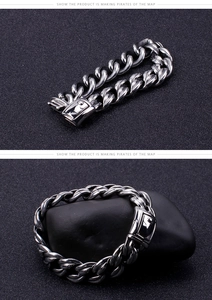 Detailed close-up of heavy Cuban link stainless steel bracelet with square mirror clasp